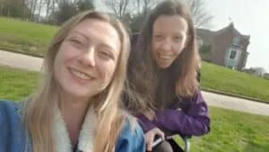 A couple of women sitting outside.